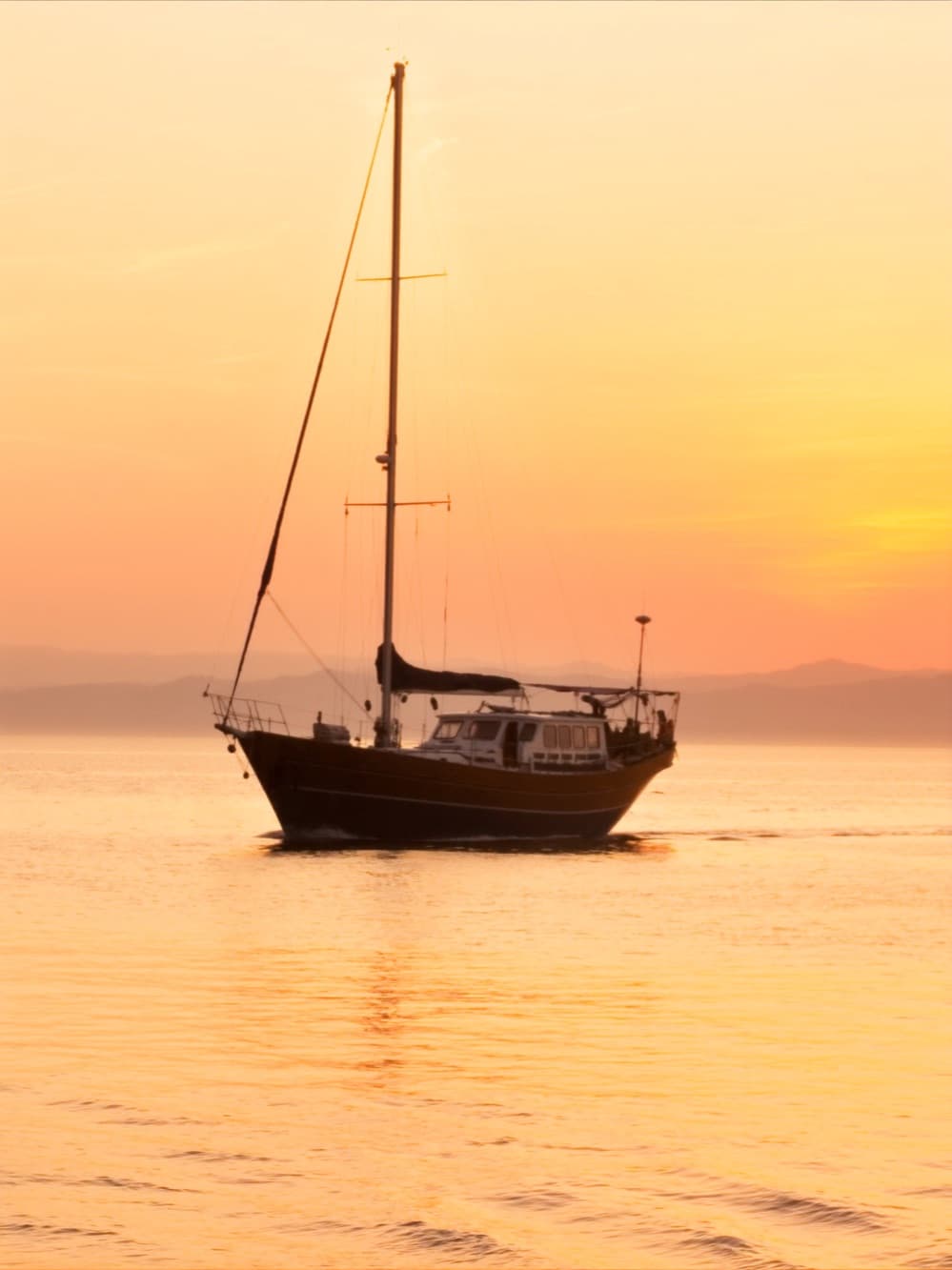 Sailboat at golden sunset on Banderas Bay
